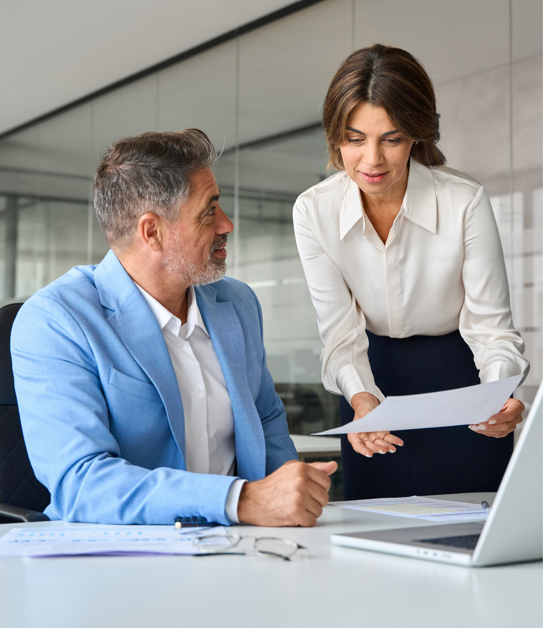 Two business professionals reviewing documents