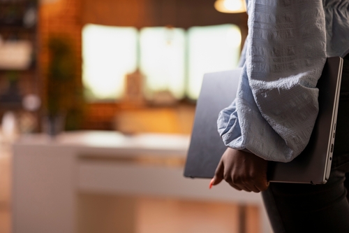 Close,Up,Of,African,American,Lady,Holding,Laptop,While,Entering