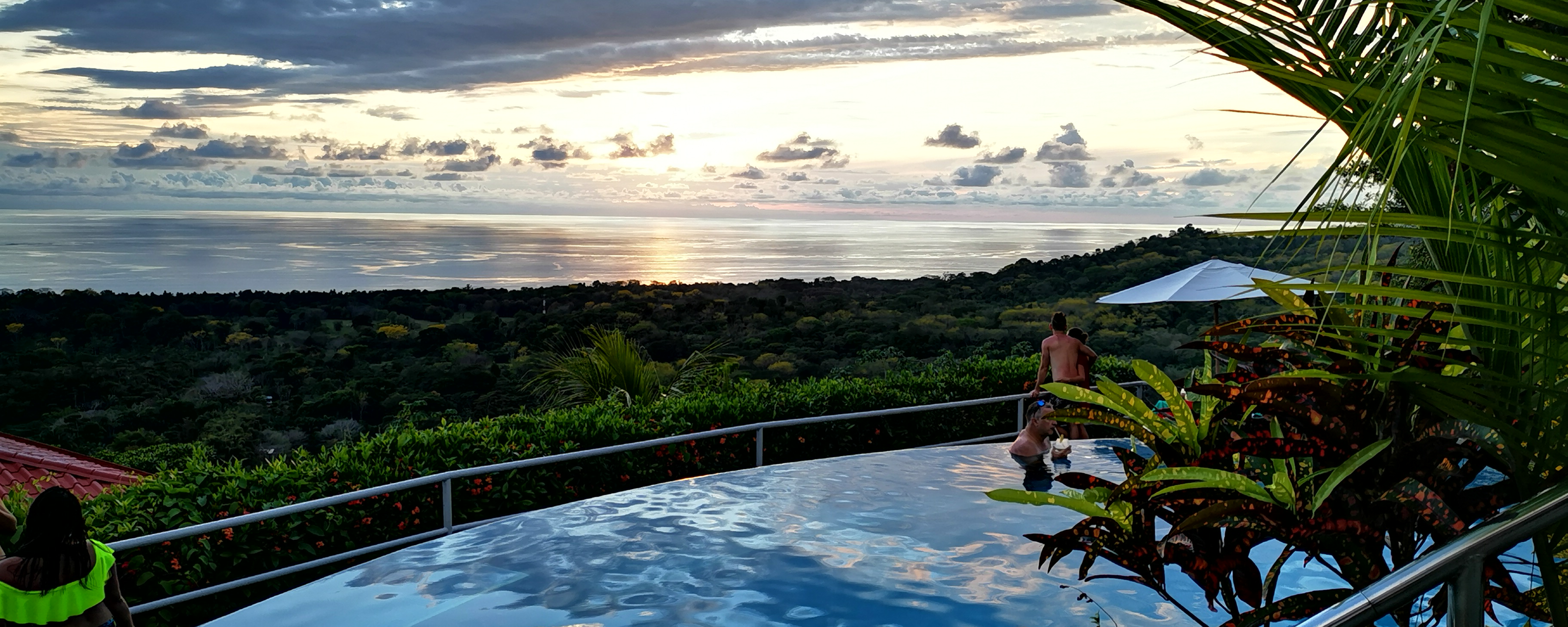 Family enjoying the infinity pool at sunset
